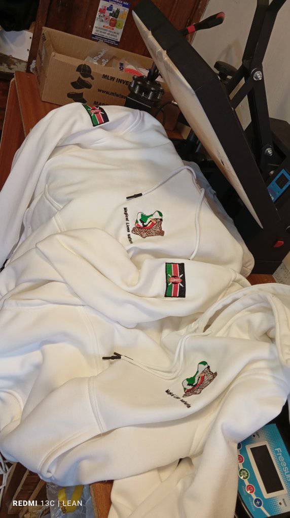 White zip hoodies with stitched chest branding and flag patches.